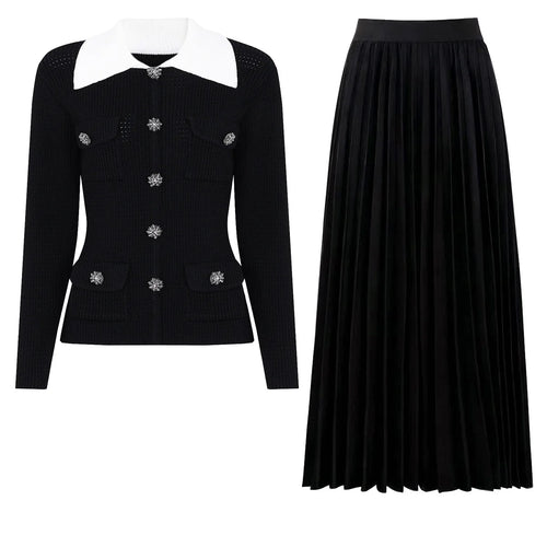 Black jacket with white collar and black pleated skirt on a white background