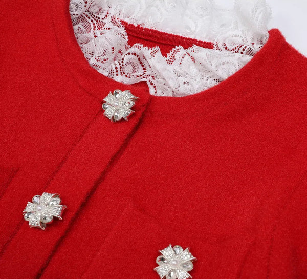 Red garment with white lace collar and silver floral buttons on a white background