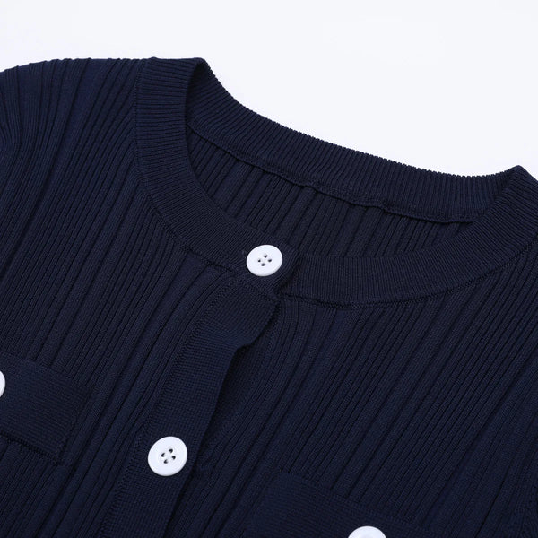 Navy blue cardigan with white buttons on a light gray background