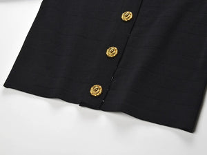 Black fabric with gold buttons on a white background