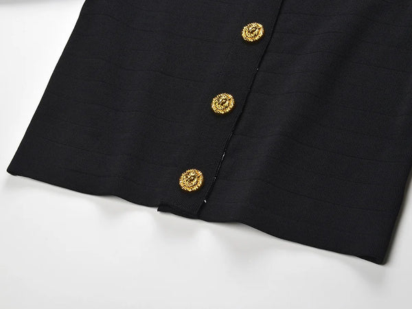 Black fabric with gold buttons on a white background