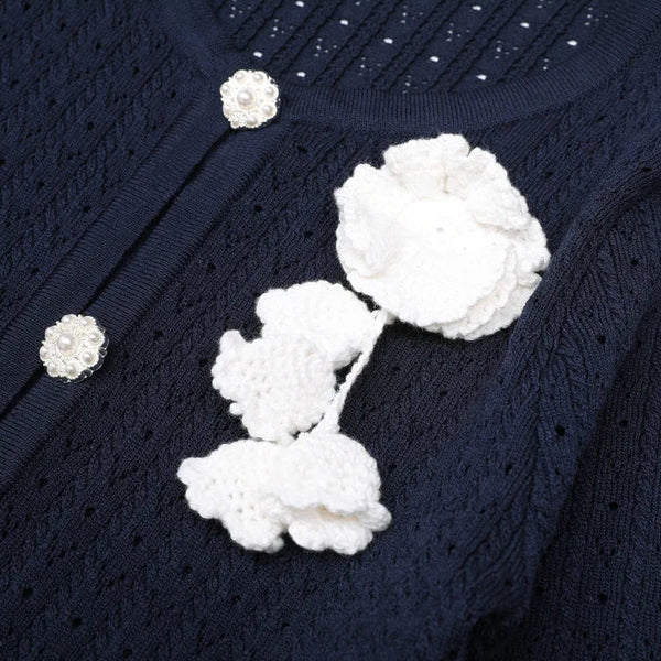 Navy blue textured fabric with white floral embellishments