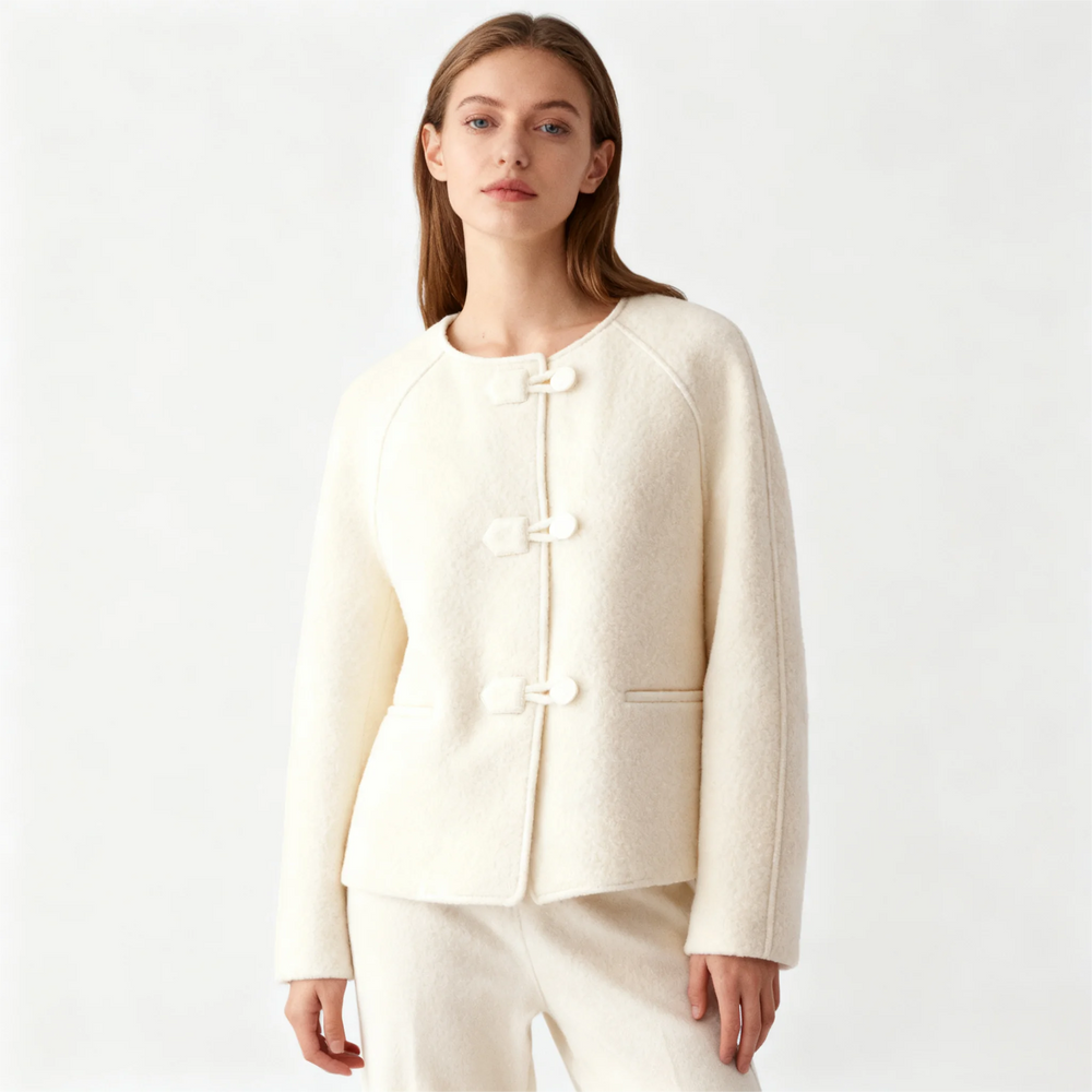 Beige jacket on a wooden hanger against a white background