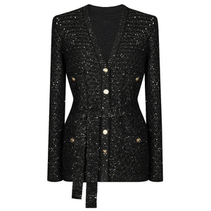 Black sequin dress with gold buttons on a white background