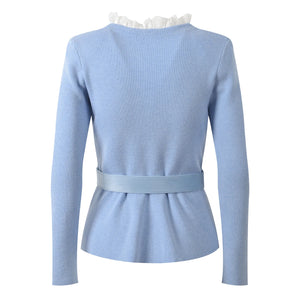 Light blue peplum top with a belt on a white background
