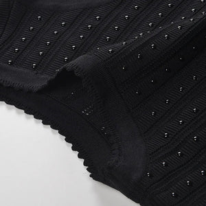 Black knit fabric with stud embellishments on a white background