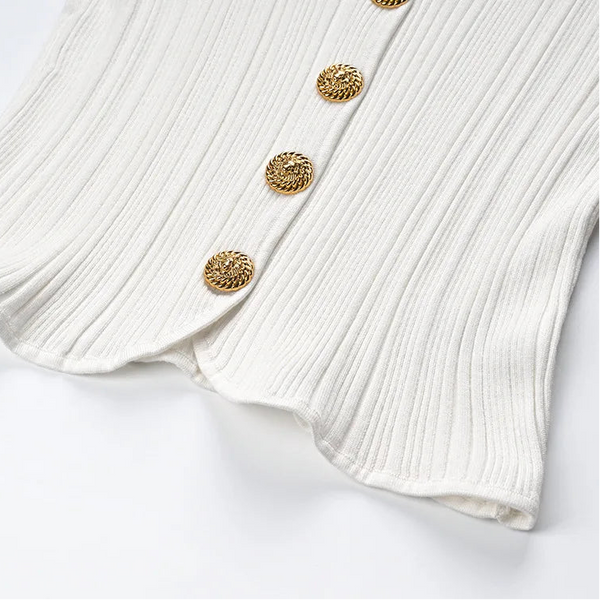 White ribbed sweater with gold buttons on a white background