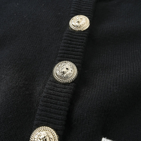 Close-up of a black garment with gold buttons
