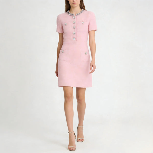 Pink dress with decorative buttons on a white background