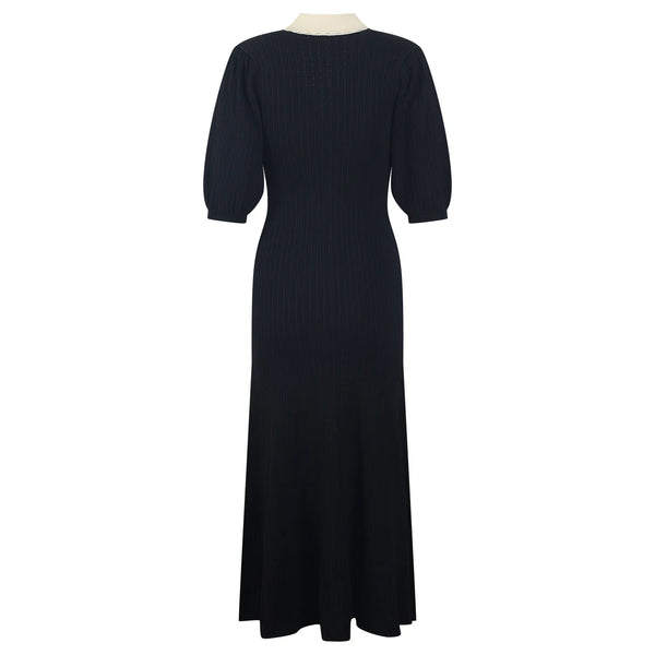 Black dress on a mannequin against a white background