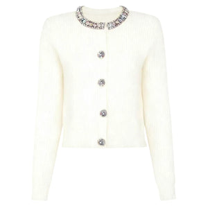 White cardigan with decorative buttons and neckline on a white background