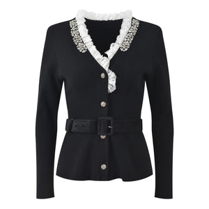 Black jacket with white lace collar and decorative buttons on a white background