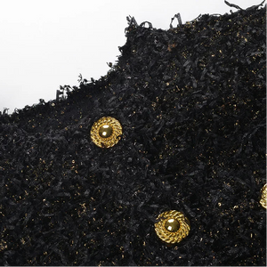 Black textured fabric with gold buttons on a white background