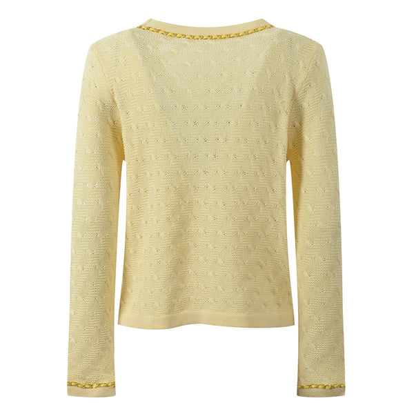 Light yellow sweater with gold trim on a white background