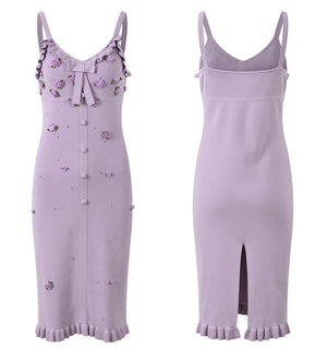 Two lavender dresses with floral embellishments on a white background