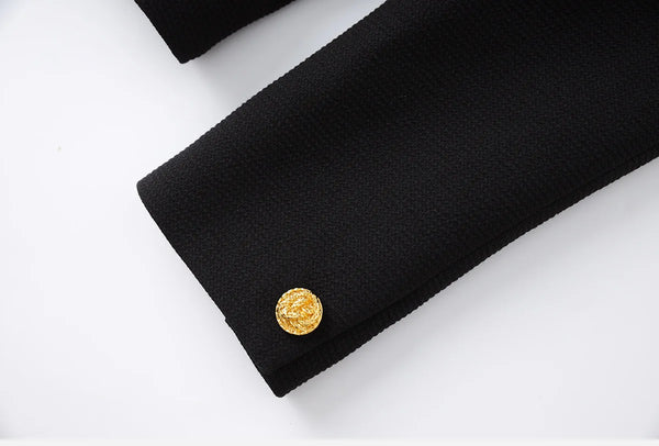 Black coat with a gold button on a white background