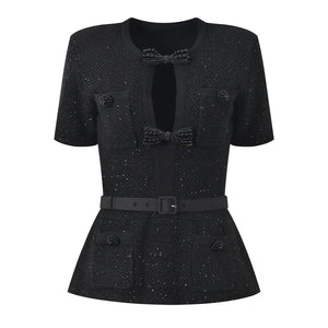 Black textured dress with a bow detail on a white background