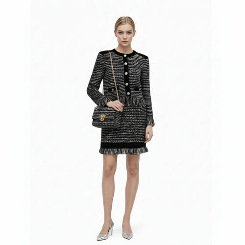 Woman wearing a black and white patterned dress on a white background