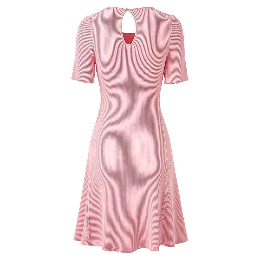 Pink dress with button details on a white background