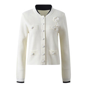 White cardigan with black trim on a white background