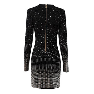 Black dress with white embellishments on a white background