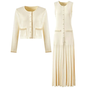 Cream-colored cardigan and pleated dress set on a white background