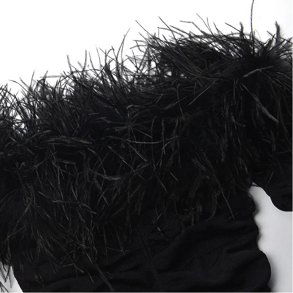 Close-up of a black fur coat with a hood on a white background
