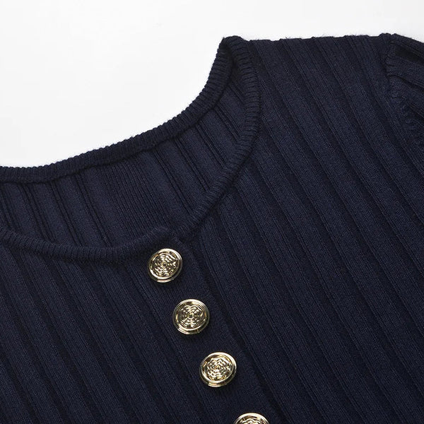 Navy blue ribbed sweater with gold buttons on a light gray background