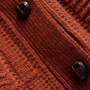 Close-up of a brown textured fabric with buttons