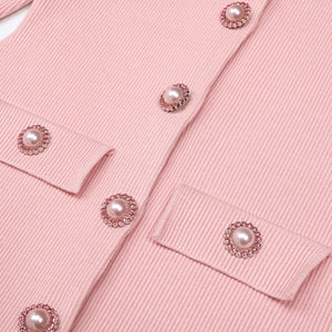 Close-up of a pink garment with pearl embellishments