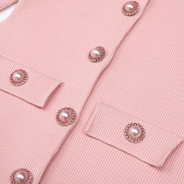 Close-up of a pink garment with pearl embellishments