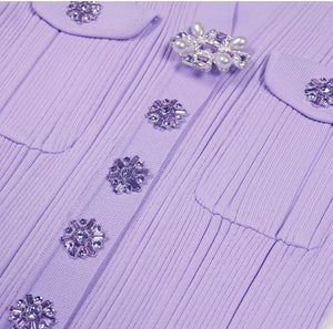 Purple sweater with decorative buttons on a light background