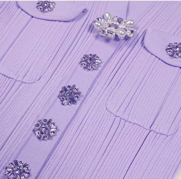Purple sweater with decorative buttons on a light background