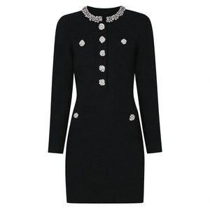 Black dress with decorative buttons and collar on a white background
