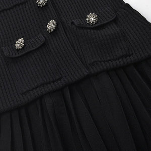 Black ribbed sweater with decorative buttons on a white background