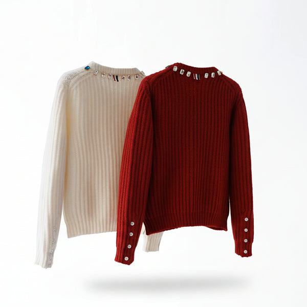 Two sweaters, one beige and one red, on hangers against a white background.