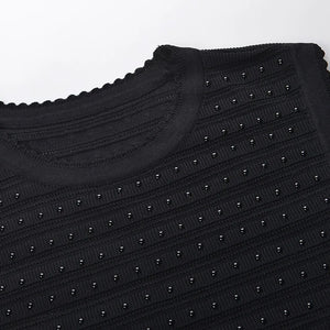Black textured sweater with stud details on a white background