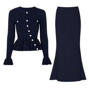 Navy blue ribbed long-sleeve top with white buttons and matching skirt on a white background
