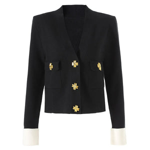 Black blazer with gold buttons on a white background