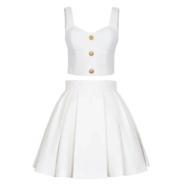 White sleeveless top with gold buttons and white pleated skirt on a white background