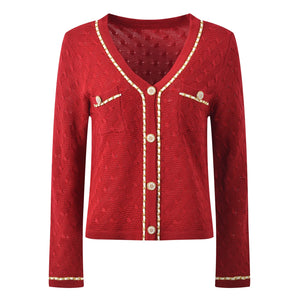 Red cardigan with gold buttons and trim on a white background