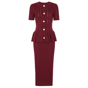 Maroon knit dress with peplum detail on a white background