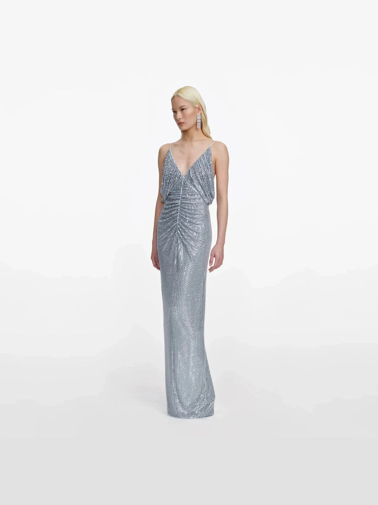 Woman wearing a silver sequin gown on a white background