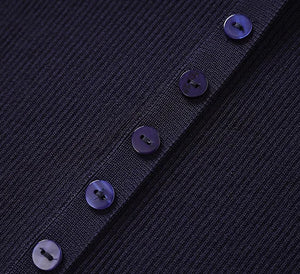 Close-up of a dark blue textured fabric with buttons