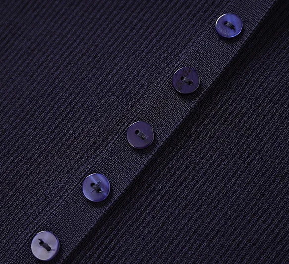 Close-up of a dark blue textured fabric with buttons