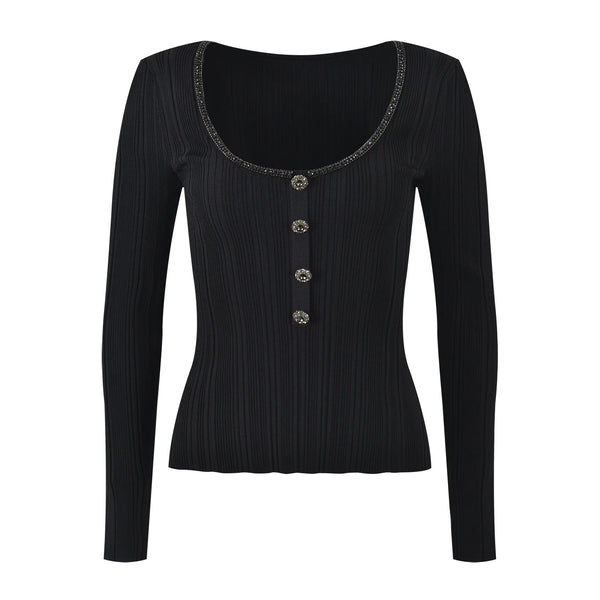 Black long-sleeve top with decorative buttons on a white background