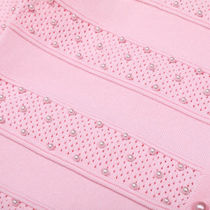 Close-up of pink fabric with pearl-like bead embellishments