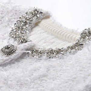 Silver bracelet with clear stones on a textured white surface
