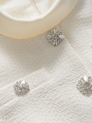 Silver stud earrings on a textured white surface
