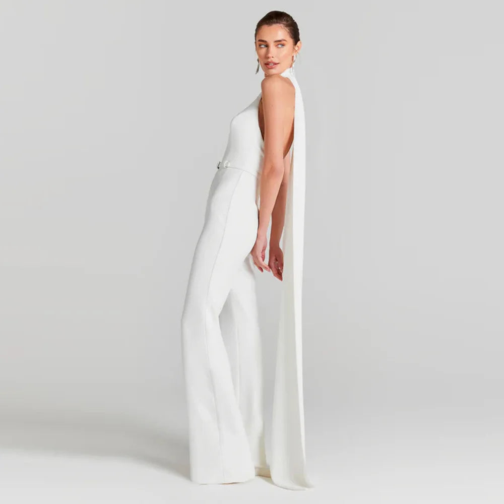 Woman wearing a white jumpsuit on a plain background